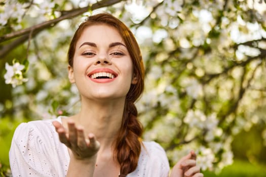 beautiful woman in blossom park smiling. High quality photo