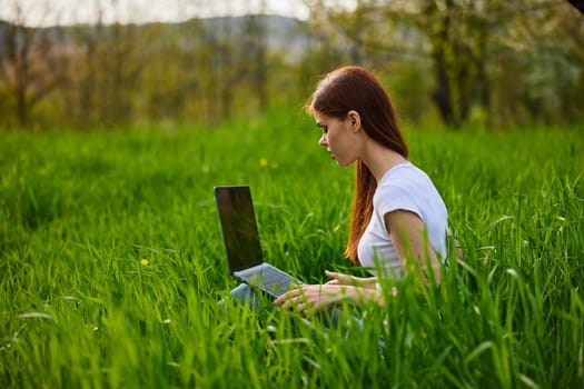 student with a laptop in the park working. High quality photo