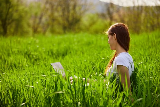 Woman with laptop working in park. High quality photo