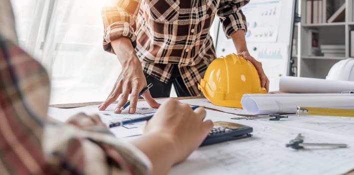 engineer people meeting working and pointing at a drawings in office for discussing. Engineering tools and construction concept...