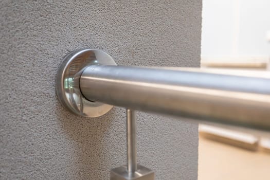 Round ore attached to the post and covered with a masking rosette. All elements of the balustrade made of stainless steel.
