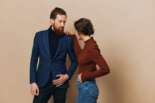 Man and woman couple in a relationship smile and interaction on a beige background in a real relationship between people. High quality photo