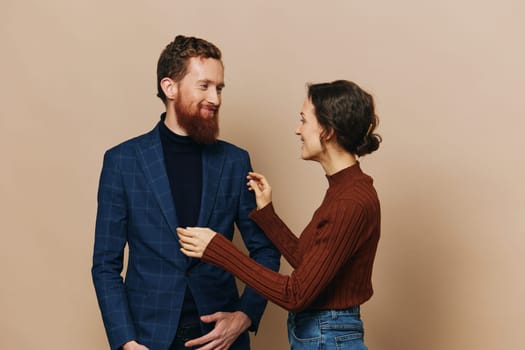 Man and woman couple in a relationship smile and interaction on a beige background in a real relationship between people. High quality photo