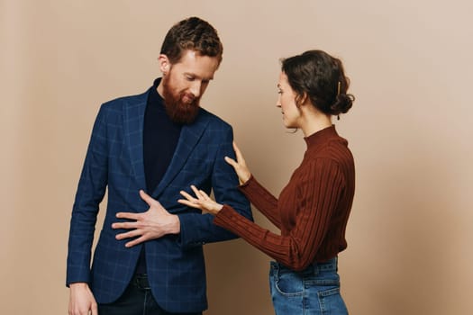 Man and woman couple in a relationship smile and interaction on a beige background in a real relationship between people. High quality photo