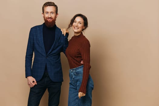 Man and woman couple in a relationship smile and interaction on a beige background in a real relationship between people. High quality photo