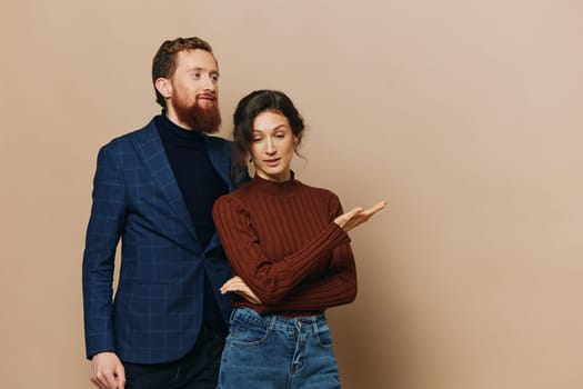 Man and woman couple in a relationship smile and interaction on a beige background in a real relationship between people. High quality photo