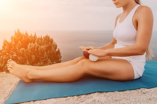 Woman sea pilates. Sporty, middle-aged woman practicing pilates in park near the sea. trains on a yoga mat and exudes a happy and active demeanor, promoting the idea of a healthy lifestyle through exercise and meditation.