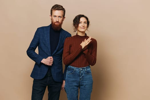 Man and woman couple in a relationship smile and interaction on a beige background in a real relationship between people. High quality photo