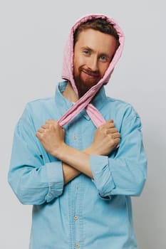 Funny man in a pink hat portrait on a light gray background. Smile and positive emotions. High quality photo