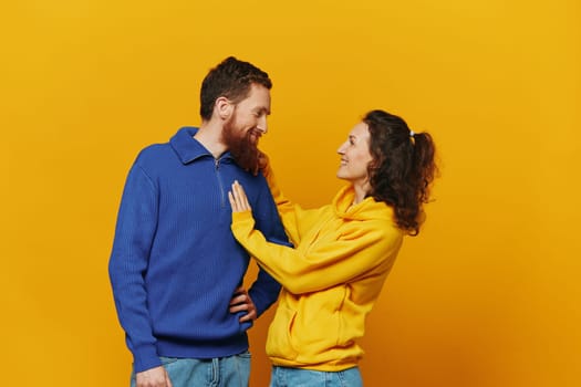 Man and woman couple smile and happiness, yellow background, family . High quality photo