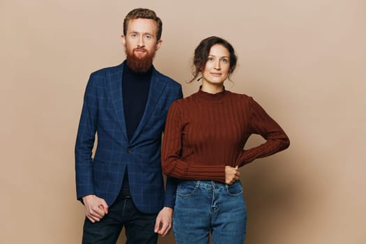 Man and woman couple in a relationship smile and interaction on a beige background in a real relationship between people. High quality photo