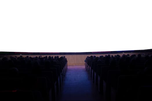People in the cinema in front of an empty white screen.