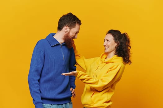Man and woman couple smile and happiness, yellow background, family . High quality photo