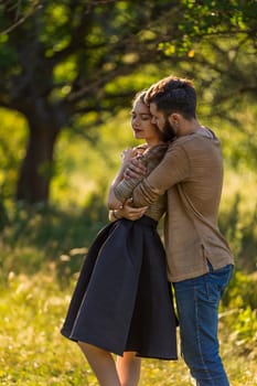 man hugging his girlfriend in nature