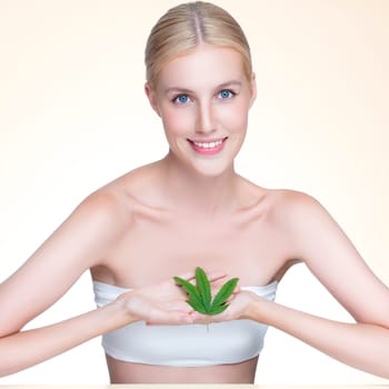 Personable beautiful woman with soft make up and flawless smooth clean skin holding green leaf. Cannabis skincare cosmetic product for natural skin treatment concept in isolated background