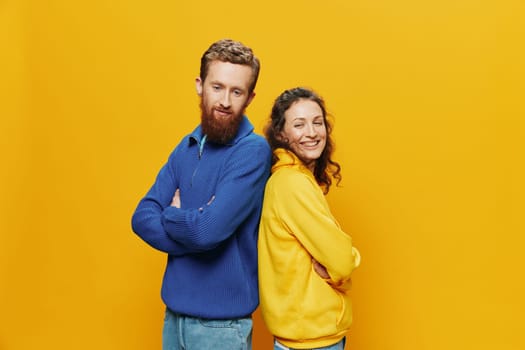 Man and woman couple smiling cheerfully and crooked with glasses, on yellow background, symbols signs and hand gestures, family shoot, newlyweds. High quality photo