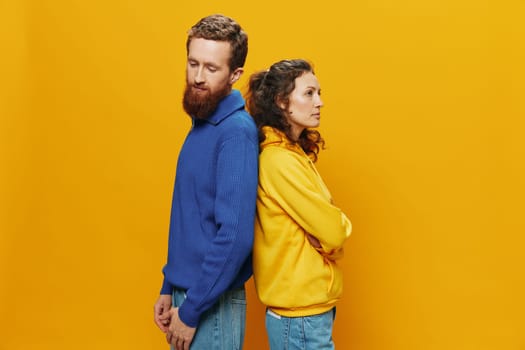 Man and woman couple smiling cheerfully and crooked with glasses, on yellow background, symbols signs and hand gestures, family shoot, newlyweds. High quality photo