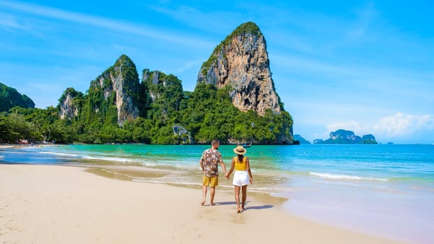 Railay Beach Krabi Thailand, the tropical beach of Railay Krabi, a couple of men and women on the beach, Panoramic view of idyllic Railay Beach in Thailand on a sunny morning