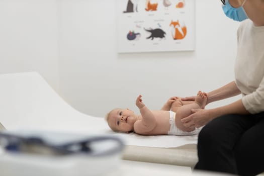 Baby lying on his back during a standard medical checkup at pediatrician.