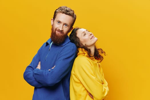 Man and woman couple smiling cheerfully and crooked with glasses, on yellow background, symbols signs and hand gestures, family shoot, newlyweds. High quality photo