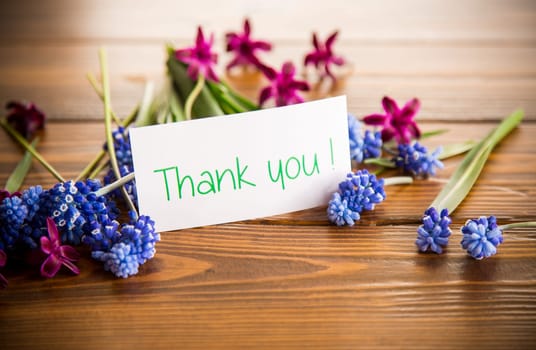 beautiful bouquet of spring flowers on a wooden table, rustic style.