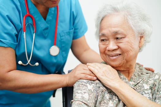 Doctor help Asian elderly woman disability patient sitting on wheelchair in hospital, medical concept.