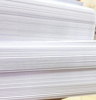 A stack of blank paper, book blocks prepared for binding in a printing house.