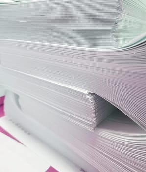 A stack of blank paper, book blocks prepared for binding in a printing house.