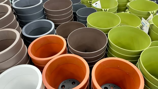 Close-up of empty flower pots in a store or greenhouse. Colorful pots for plants. Gardening and landscape design concept.