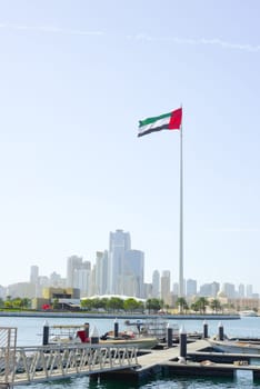 SHARJAH, UAE - February 14, 2023: Flag of the United Arab Emirates in Sharjah on the coastline