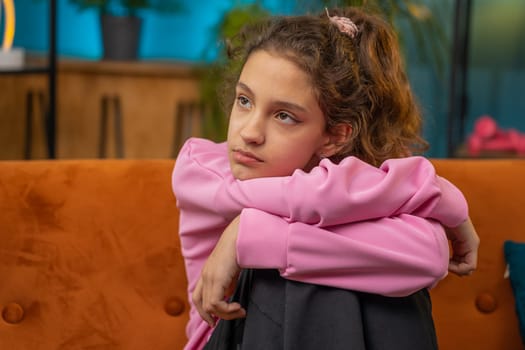 Portrait of sad Caucasian preteen girl suffers from unfair situation, unrequited love, violence abuse, bullying in family. Young child kid suffers from fail of school education exam results at home