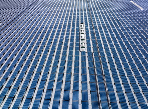 Rows of panels in grid at floating solar farm on sunny day. High quality photo