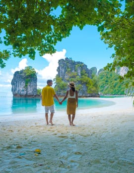 Koh Hong Island Krabi Thailand, a couple of men and women on the beach of Koh Hong, a tropical white beach with Asian women and European men in Krabi Thailand on vacation