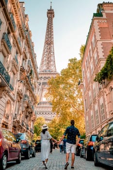 couple men and woman honeymoon Paris Eiffel tower France, couple men and woman city trip in Paris during summer