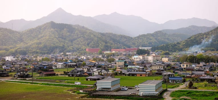 Apartments and houses in small town in rural valley between mountains. High quality photo