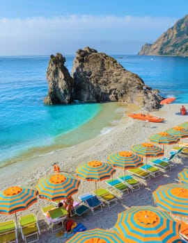 Pebble beach Monterosso vacation Cinque Terre Monterosso Chairs and umbrellas fill the Spiaggia di Fegina beach, Monterosso, part of the Cinque Terre Italy.