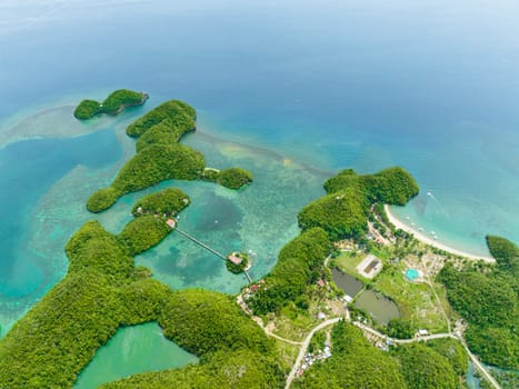 Aerial view of tropical islands in a beautiful bay with turquoise water and lagoon. Sipalay, Negros, Philippines.
