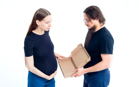 Portrait happy young pregnant woman and her husband with shopping bags and touching her big belly isolated on white background. Pregnancy shopping concept happy young family with shopping bags