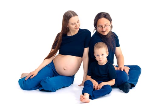 beautiful european happy family with a pregnant mother, the father and a son together. High quality photo