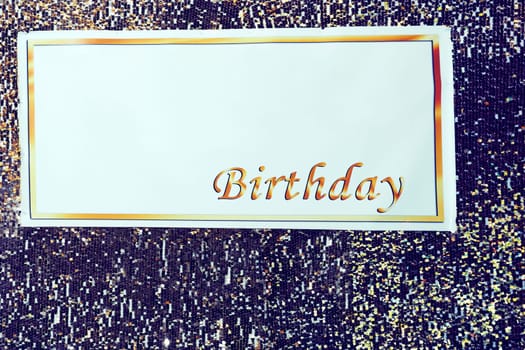 a long strip of cloth bearing a slogan or design, hung in a public place or carried in a demonstration or procession