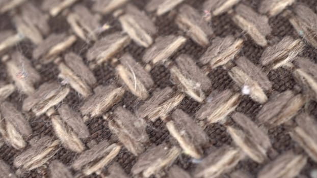 Wicker gray fabric macro. The camera shoots a plaid in the motion of a dolly. 4k