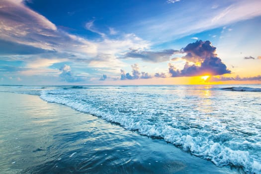 Beach sunrise or sunset over the tropical sea and sky with clouds