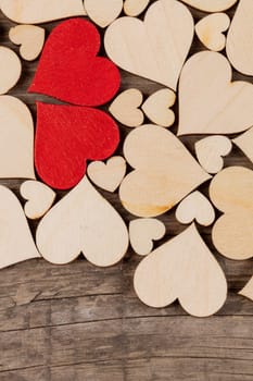 Many wooden colorless hearts background, two red special ones true love concept