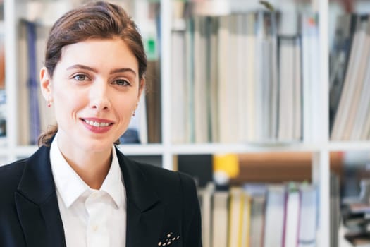 Portrait of business woman in office with many document folders on background