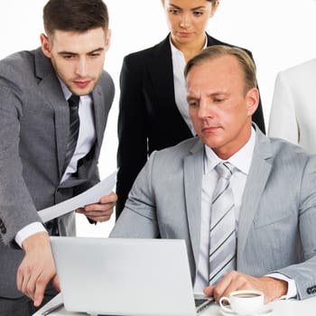 Business team working with laptop and documents together