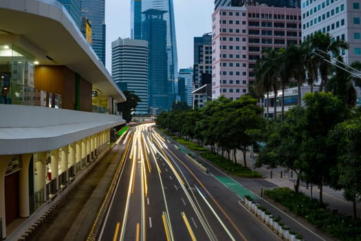 Jakarta, Indonesia. April 23, 2023. The city light trails against the buildings. On Jalan Jenderal Sudirman. Jakarta. Long Exposure Photography. Motion blur.