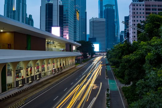 Jakarta, Indonesia. April 23, 2023. The city light trails against the buildings. On Jalan Jenderal Sudirman. Jakarta. Long Exposure Photography. Motion blur.
