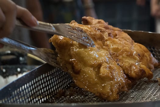The fried cempedak which is the fruit similar with jackfruit but with strong smell and softer. Covered with flour. Food photography.
