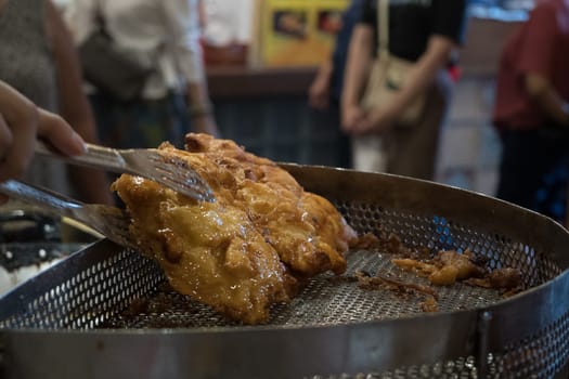 The fried cempedak which is the fruit similar with jackfruit but with strong smell and softer. Covered with flour. Food photography.