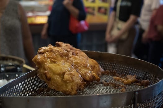 The fried cempedak which is the fruit similar with jackfruit but with strong smell and softer. Covered with flour. Food photography.